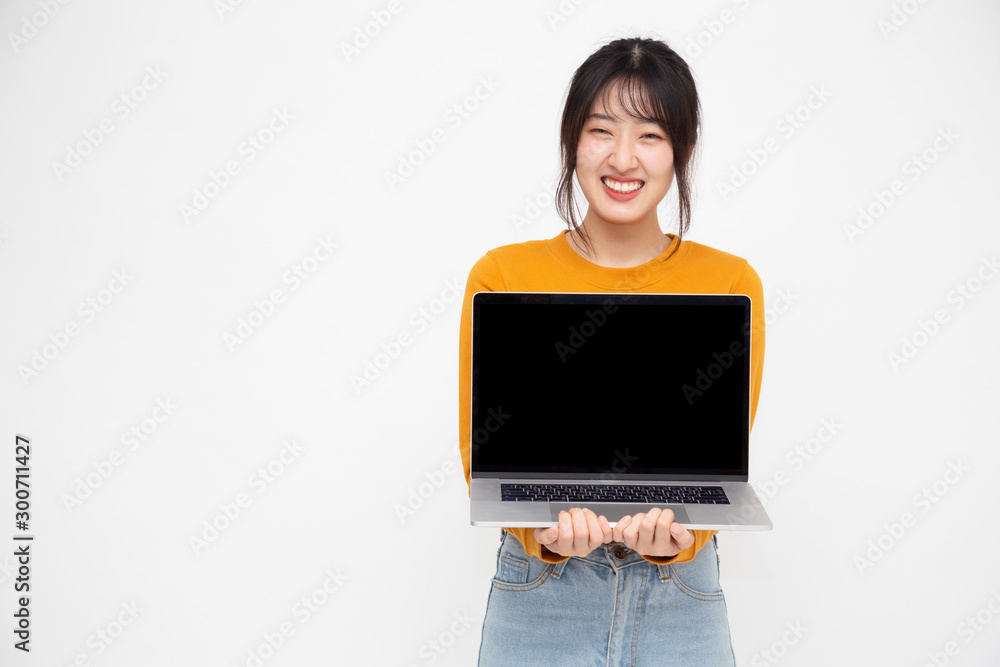 Young Asian woman showing a laptop computer over white background with copy space for presenting application or website online or products Young Asian woman showing a laptop computer over white background with copy space for presenting application or website online or products
