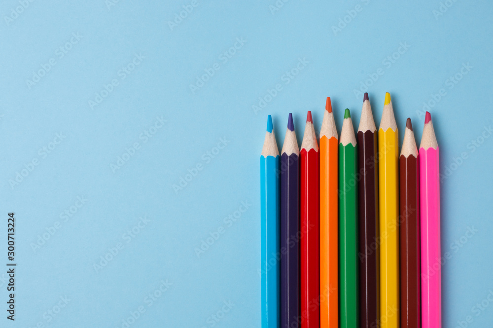 Multiсolored pencils on a blue background Multiсolored pencils on a blue background