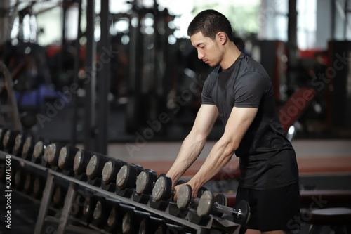 Asian man exercising in the gym. fitness health body good.