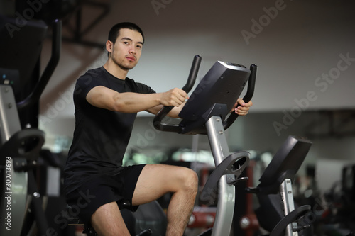 Asian man exercising in the gym. fitness health body good.