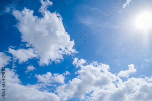 the blue sky with a lot of cloud and sun in frame