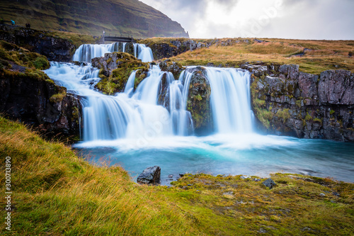 The picturesque sunset over landscapes and waterfalls. Kirkjufell mountain  Iceland