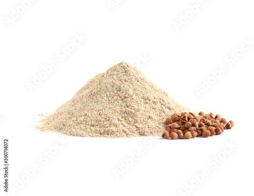 Pile of buckwheat flour and grains on white background photo