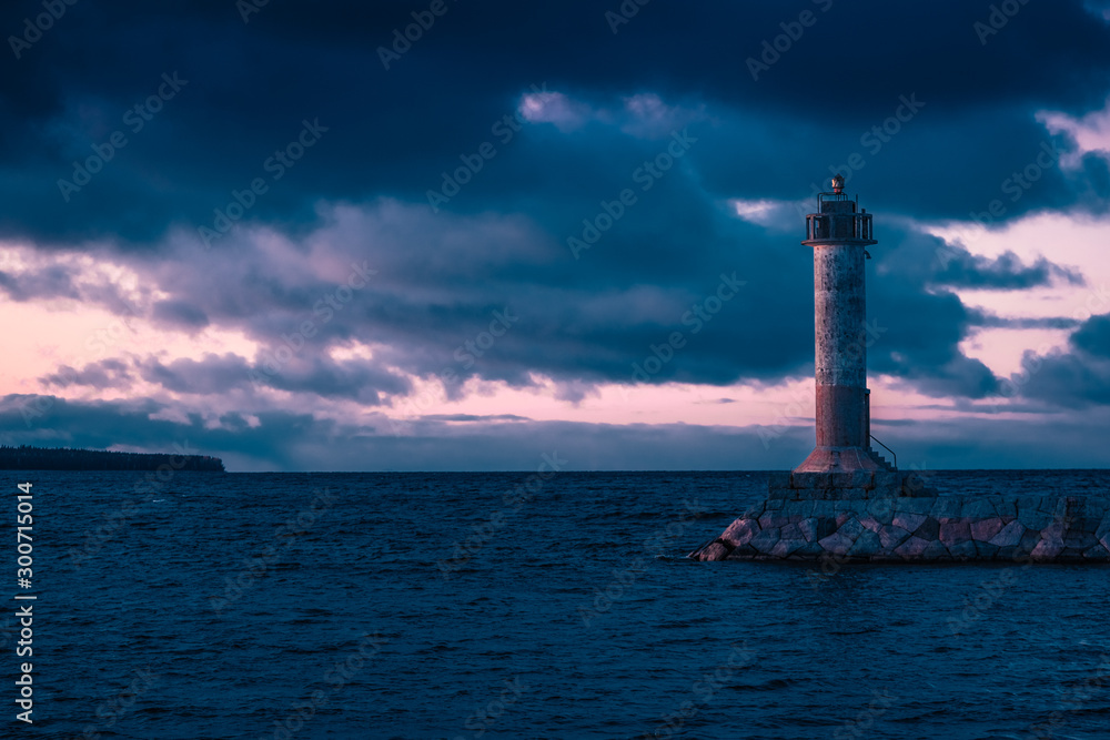 Stunning long exposure landscape lighthouse at sunset with calm. Water.