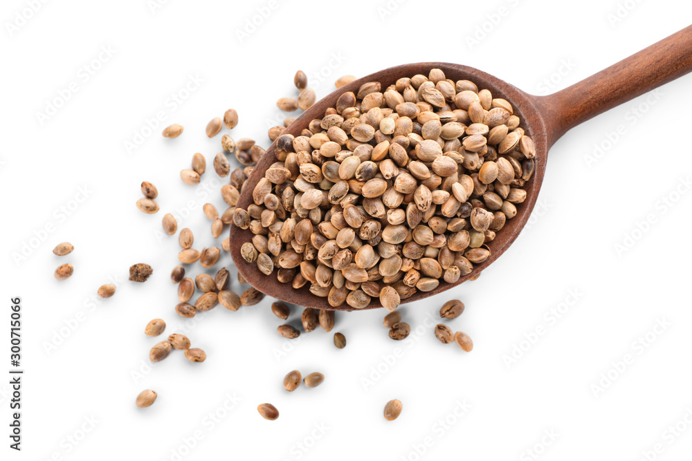 Wooden spoon with hemp seeds on white background, top view Wooden spoon with hemp seeds on white background, top view