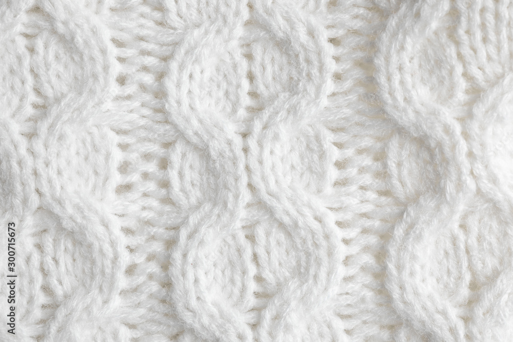 White knitted sweater as background, closeup view White knitted sweater as background, closeup view