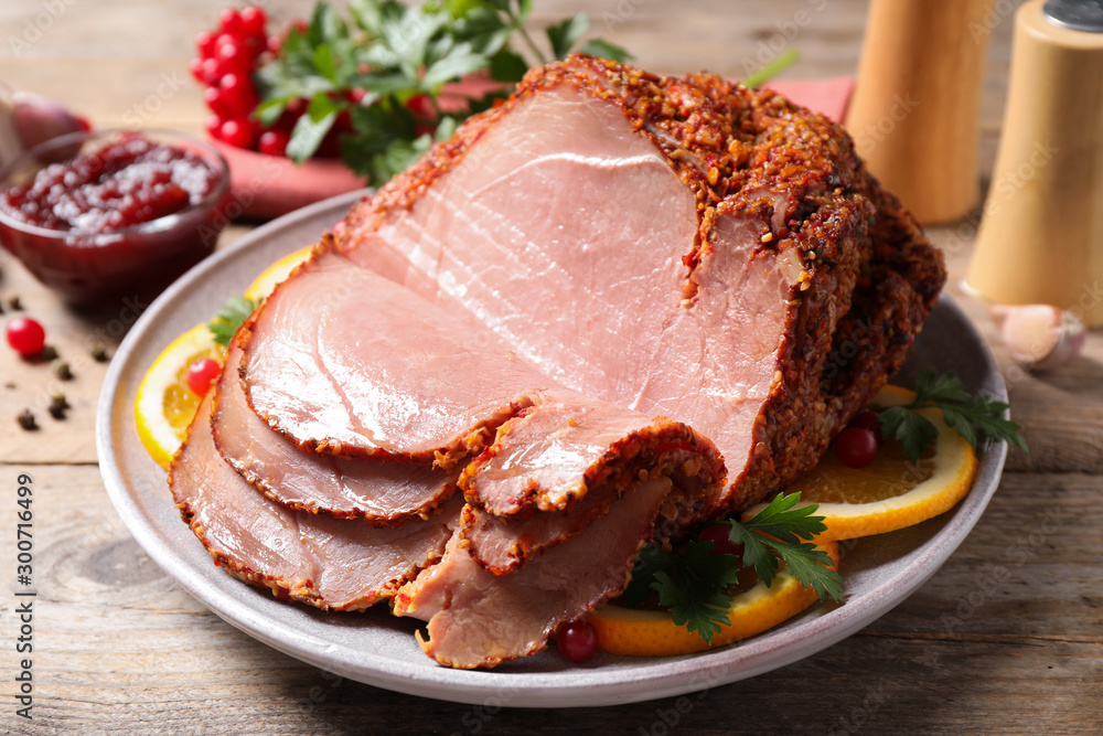 Delicious ham served with garnish on wooden table Delicious ham served with garnish on wooden table