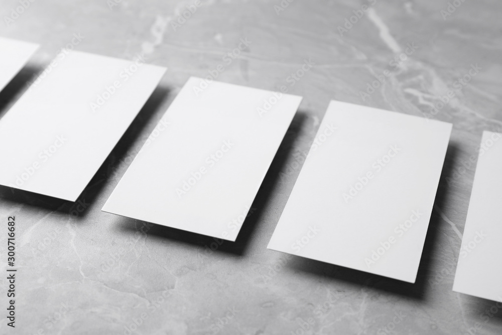 Empty sheets on grey marble table. Mock up for design Empty sheets on grey marble table. Mock up for design