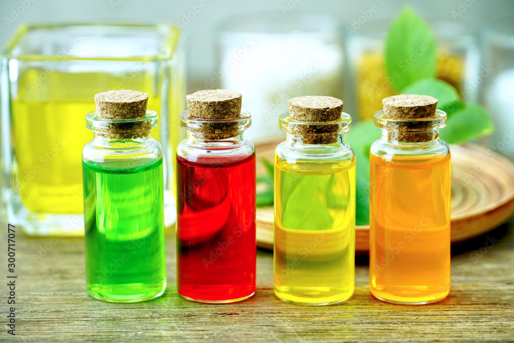 Closeup four organic oil in the bottles on the table for produce apothecary cosmetic product. Closeup four organic oil in the bottles on the table for produce apothecary cosmetic product.