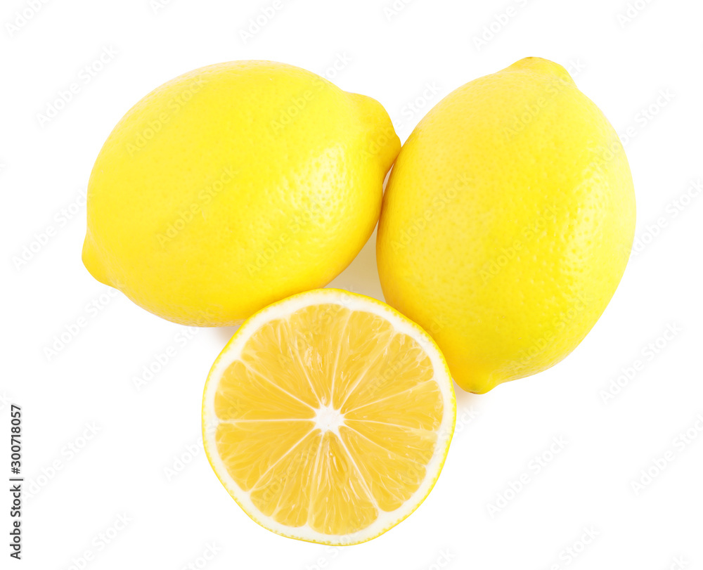 Sliced and whole fresh lemons on white background, top view