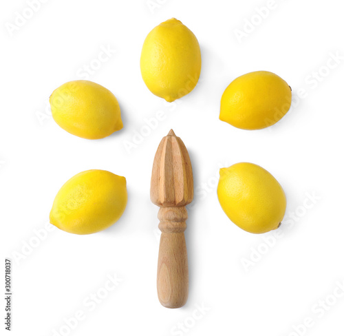 Tasty fresh lemon and wooden squeezer on white background, top view photo