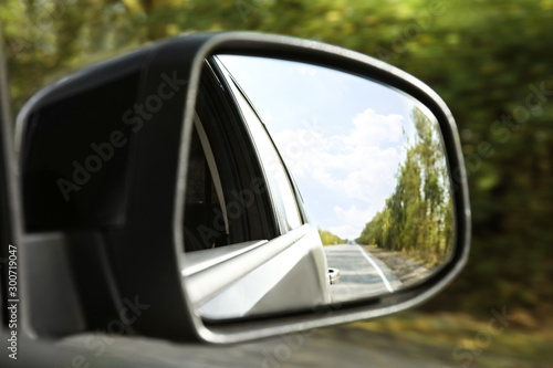 Closeup of car side rear view mirror on sunny day © New Africa