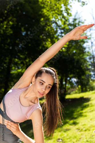 Young athletic girl is doing corps stretching outdoor