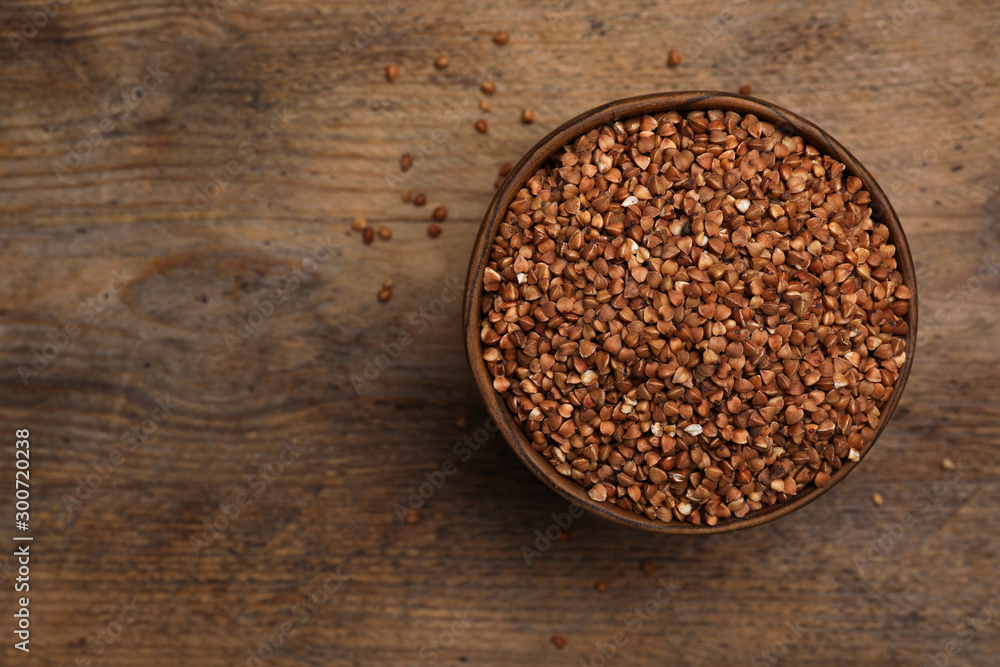 Buckwheat grains on wooden table, top view. Space for text Buckwheat grains on wooden table, top view. Space for text