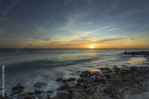 Gorgeous colorful view of sunset on Aruba. Beautiful nature landscape. Rocky coast of Atlanta, Caribbean. © Alex