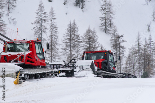 Obertauern / Austria - March 02, 2019: red snowcats parked at the bottom of the ski slopes in the ski resort