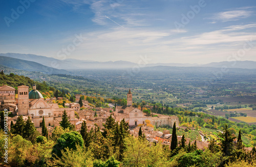 View of Assisi charming historic center and Umbria countryside seen from Rufinus Hill with haze in the background