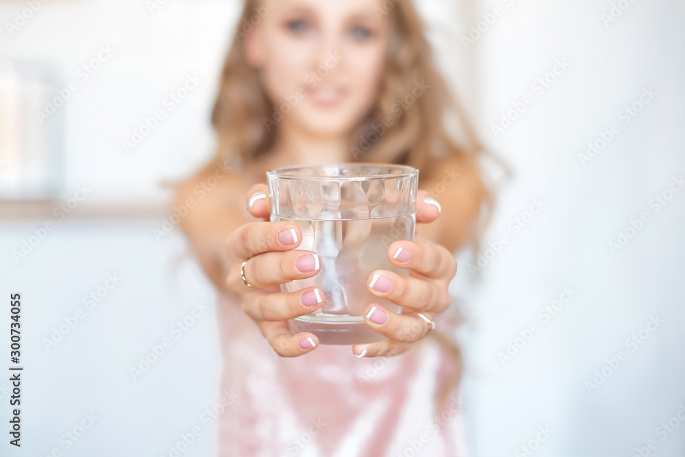 Female hands holding a transparent glass of water. Healthy lifestyle Female hands holding a transparent glass of water. Healthy lifestyle