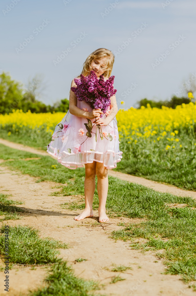 charming caucasian child with lilac bouquet in hands charming caucasian child with lilac bouquet in hands