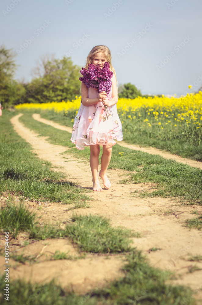 charming caucasian child with lilac bouquet in hands charming caucasian child with lilac bouquet in hands