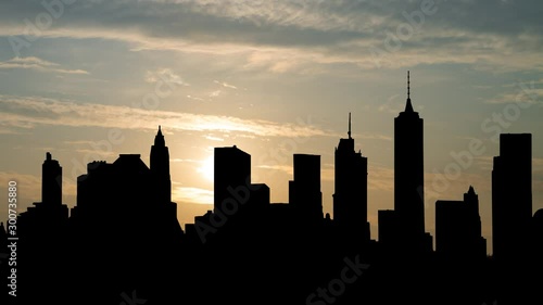 Brooklyn Skyline at Sunrise, Time Lapse with Silhouette of Skyscrapers and Colorful Clodus, Manhattan, New York , USA photo