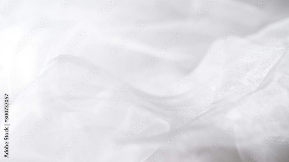 Obraz premium Weißer Tüllstoff für Brautkleider als Hintergrund.
