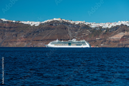 A cruise ship on the blue Aegean Sea near Santorini Island in the Greek Islands © Phillip