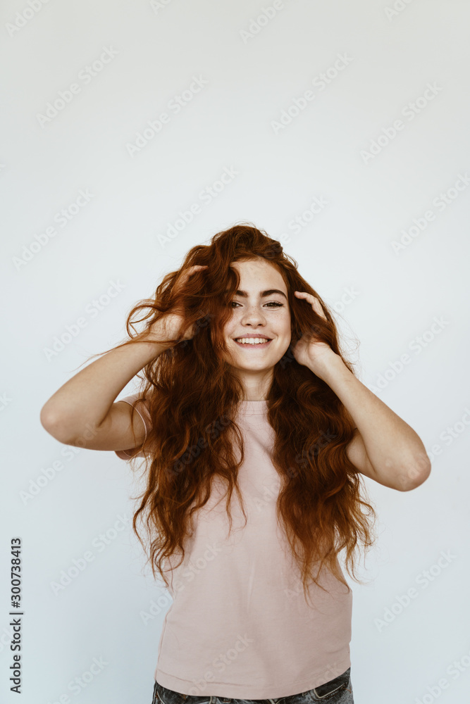schoolgirl laughs and fumbles hair with her hands. bright studio schoolgirl laughs and fumbles hair with her hands. bright studio
