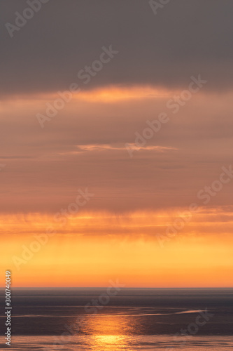 sunset on the sea. the sun behind the cloud © mazurevanasta