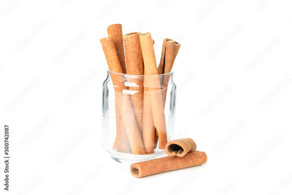 Cinnamon sticks in glass jar isolated on white background