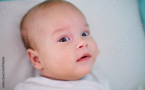 Closeup portrait of a baby in bed.