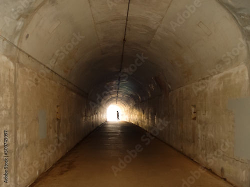 Woman going to the light of a tunnel