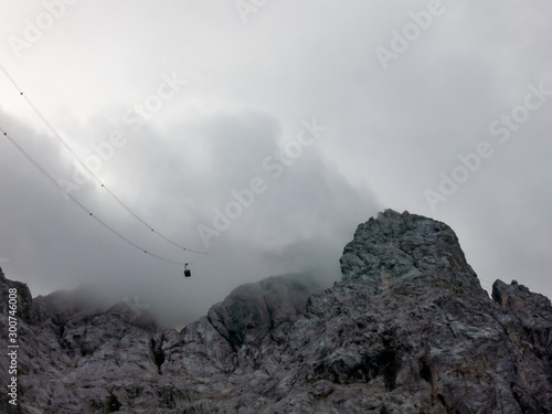 Cablecar riding towards cloudy mountaintop