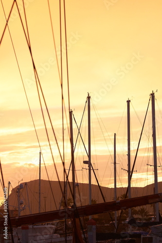 Sunset in the port. Photo with masts on the sunset. Ensenada. Baja California. Mexico.