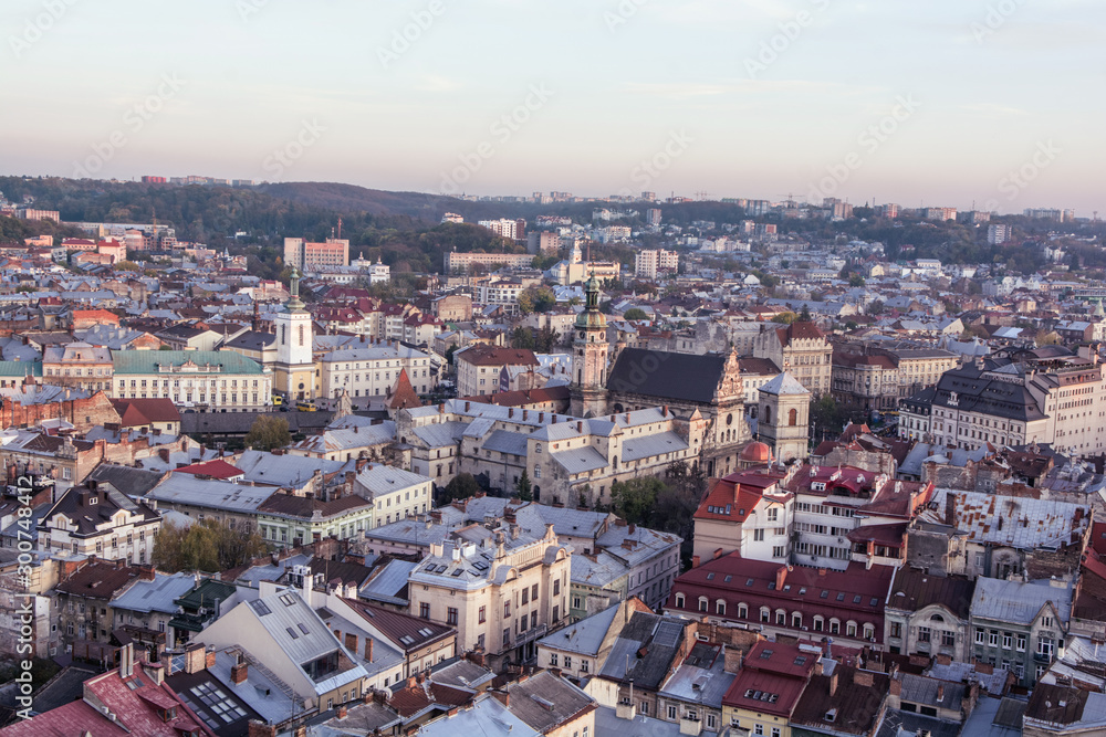 Lviv, Ukraine - October 24, 2019: Beautiful Ratusha view of the historic center of Lviv, Ukraine, on a sunny evening. Andriy's church, roofs and streets.