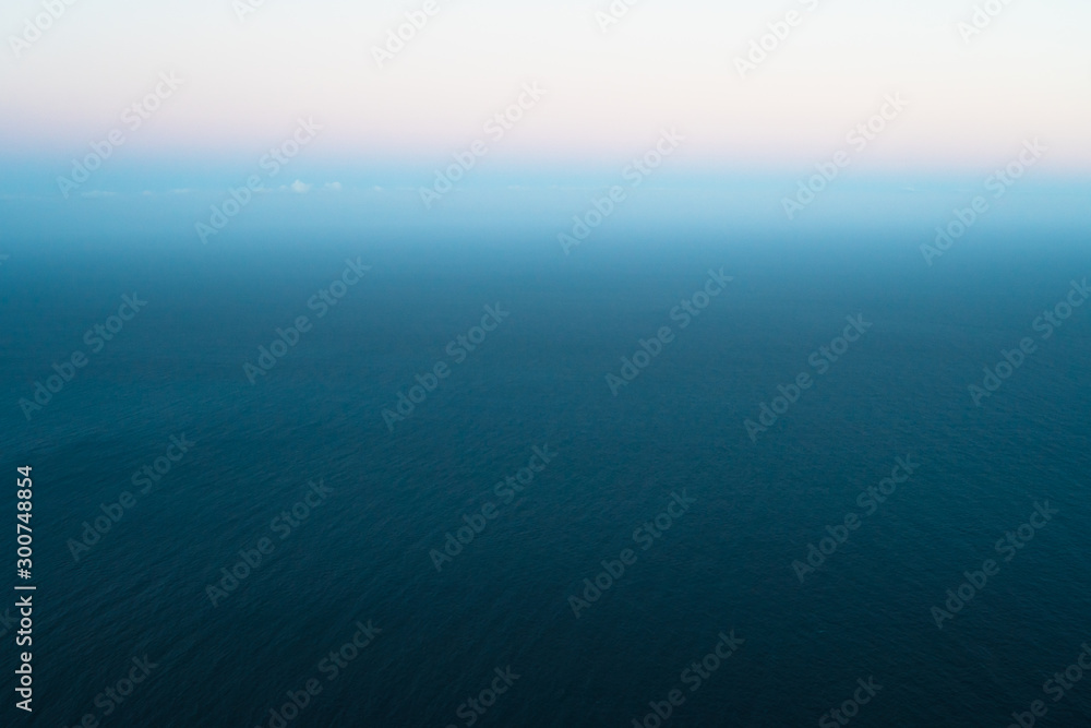 Idyllic colorful seascape background while sunset Idyllic colorful seascape background while sunset