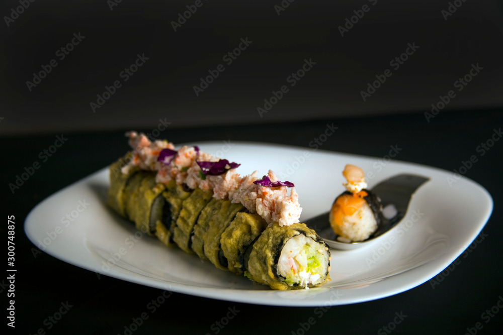 Plate with a sushi roll and a gourmet nigiri Plate with a sushi roll and a gourmet nigiri