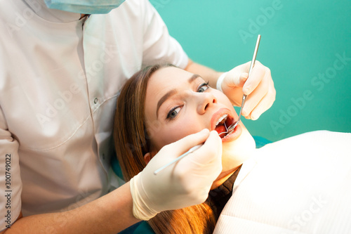 Girl treats teeth at the dentist. Dental treatment close-up