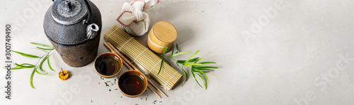 Obraz na plátně Still life with tea set, furoshiki wrapping present gift, scattered tea, bamboo mat, chopsticks, incense