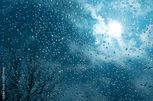 Beautiful sky and clouds, rain, wet glass, drops of water on the glass, drops of water on the window, drops