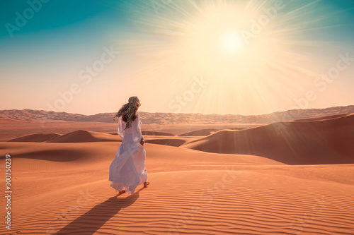 UAE. Woman in desert photo