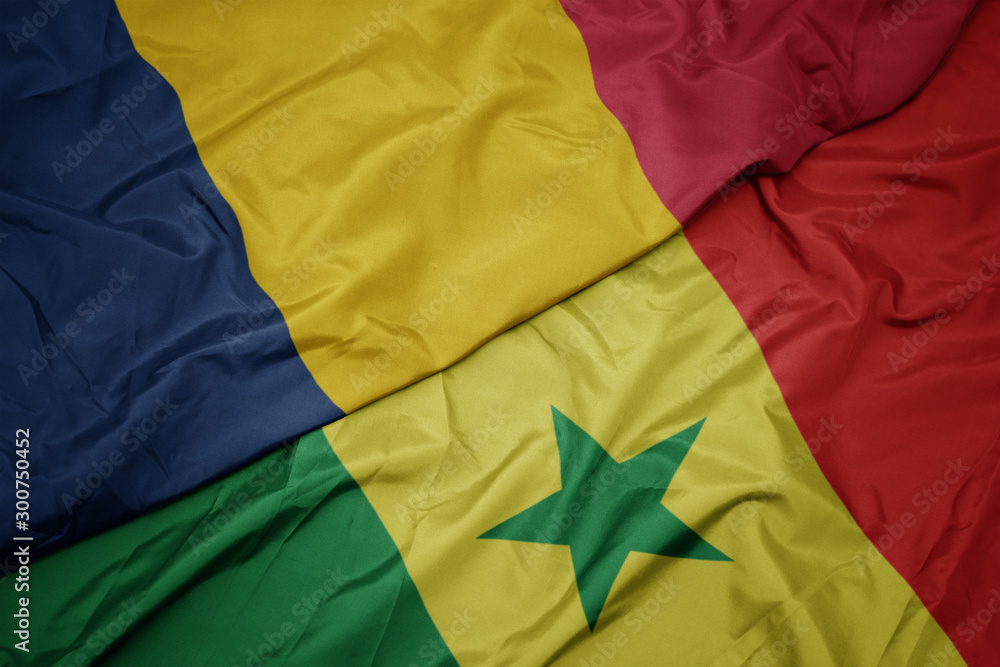 waving colorful flag of senegal and national flag of chad. waving colorful flag of senegal and national flag of chad.