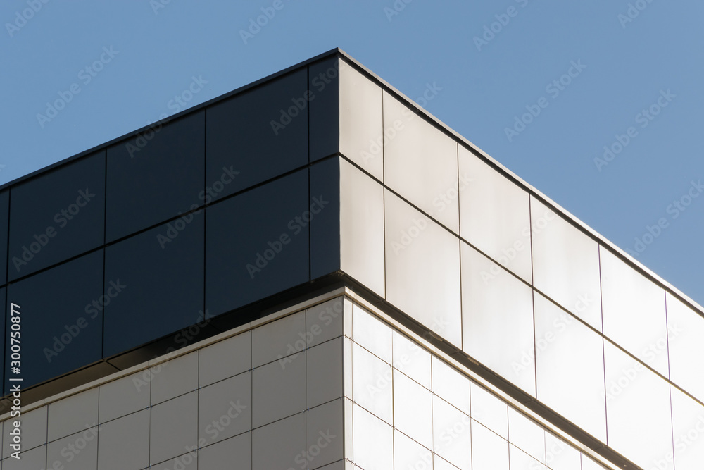 Geometric colored building facade elements with planes, lines and corners with light flare and reflections for an abstract background and texture of white, blue, gray colors. Place for text Geometric colored building facade elements with planes, lines and corners with light flare and reflections for an abstract background and texture of white, blue, gray colors. Place for text
