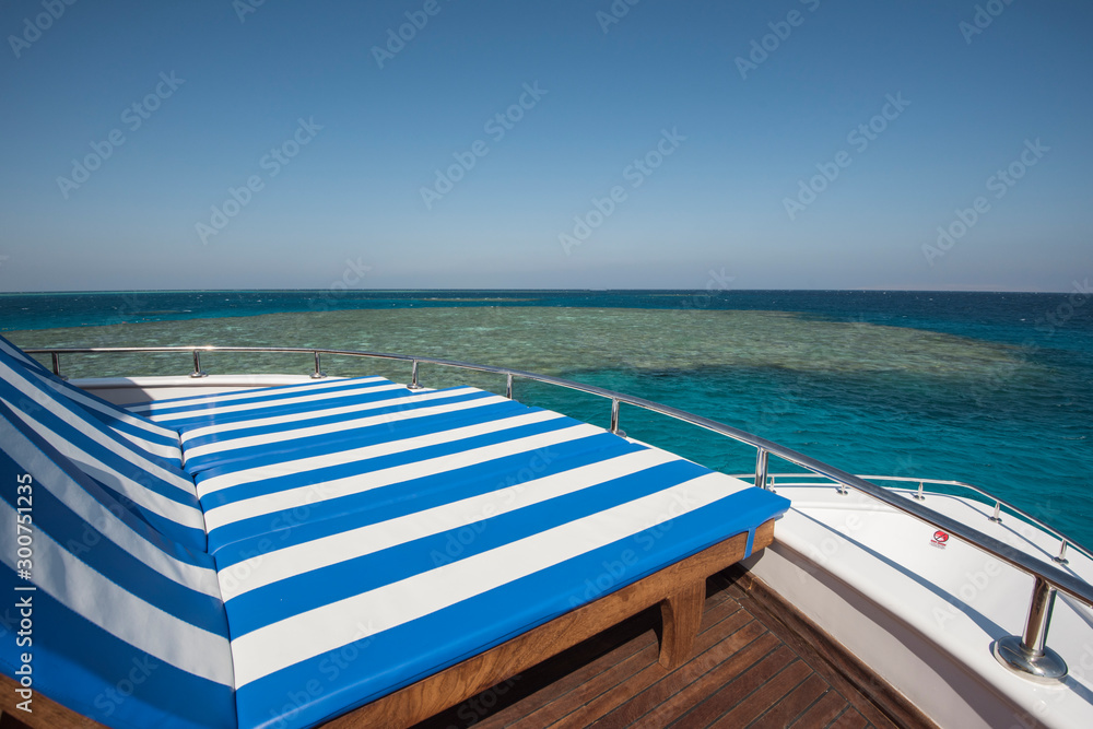 Fototapeta premium Sun loungers on the bow of a large luxury motor yacht
