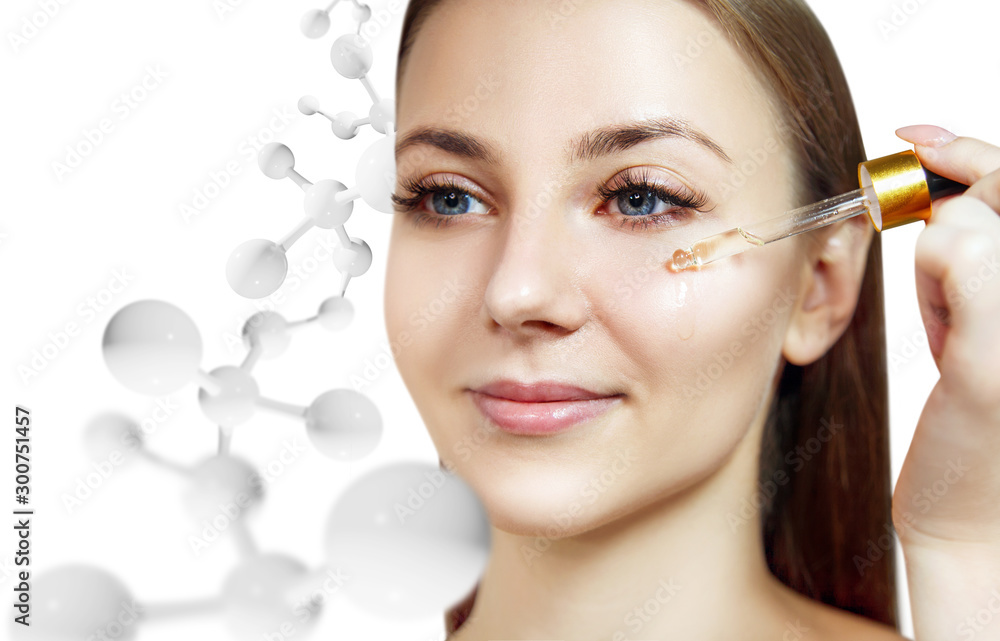 Woman with oil on face among white molecules structure.