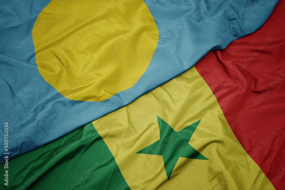 waving colorful flag of senegal and national flag of Palau . waving colorful flag of senegal and national flag of Palau .