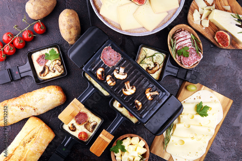 Canvas Print Delicious traditional Swiss melted raclette cheese on diced boiled or baked potato