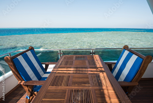 Table and chairs on deck of a luxury motor yacht