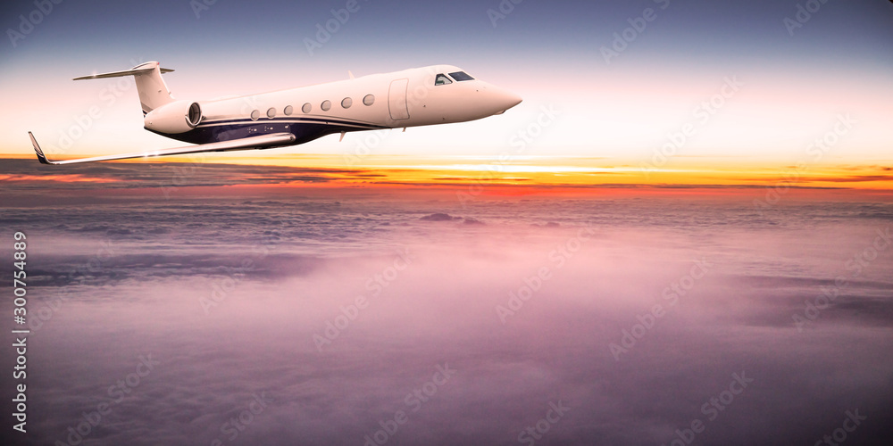 Private jet plane flying above dramatic clouds during sunset. Private jet plane flying above dramatic clouds during sunset.