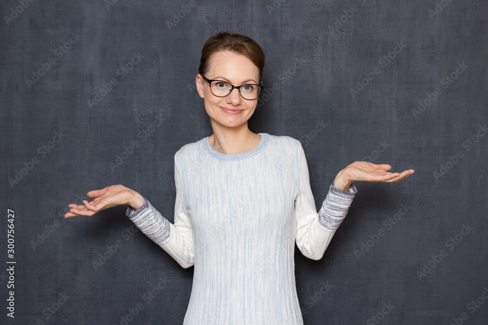Portrait of happy woman stretching hands and shrugging shoulders Portrait of happy woman stretching hands and shrugging shoulders